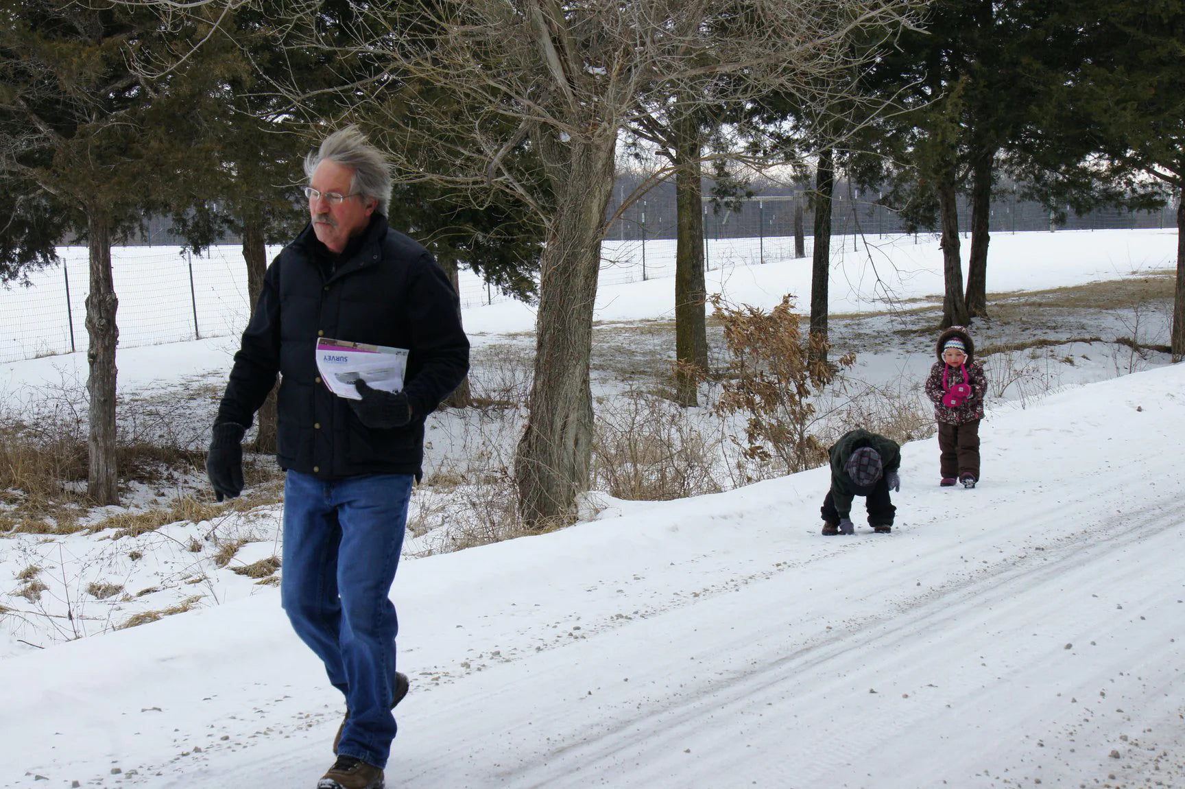 Bernie Rothrock on his property with his grandkids in winter