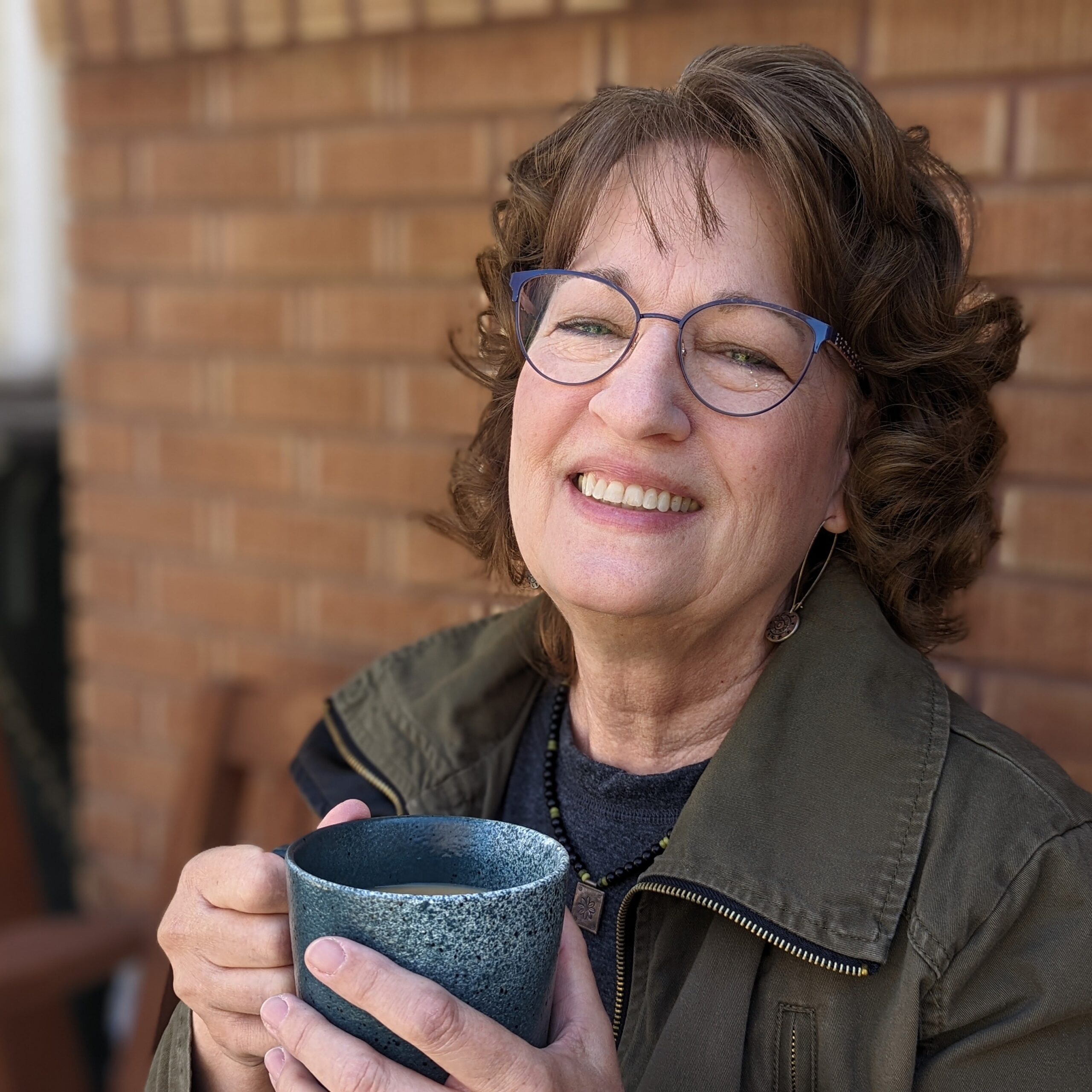 Trisha Trout drinks a coffee on a porch