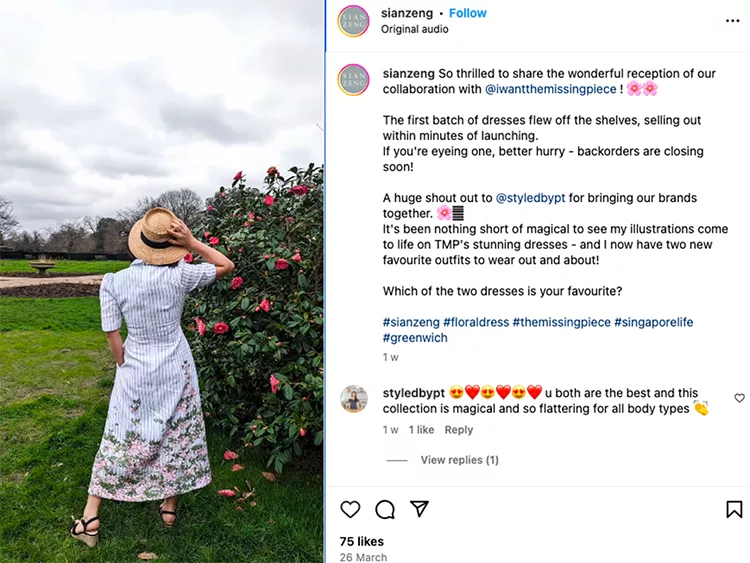 A woman in a floral dress and hat stands on a grassy field, facing away from the camera, with cherry blossoms in the background. Instagram post details a clothing collaboration and launch success.