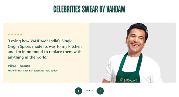 Promotional image featuring a male chef in a white shirt and green apron. He endorses Vahdam India's Single Origin Spices, stating their quality and his reluctance to replace them. Text and brand logos included.