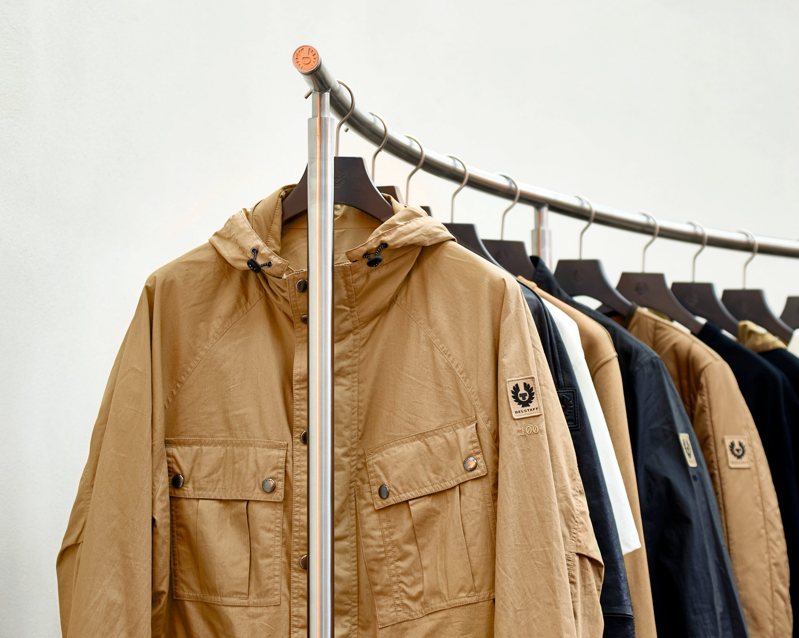 Belstaff jackets on a rack with the phoenix logo on the arm