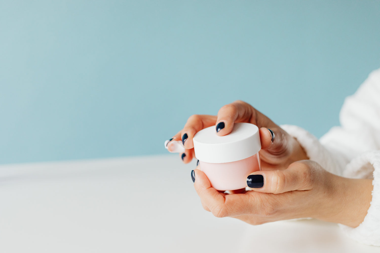 Woman holds generic skincare packaging