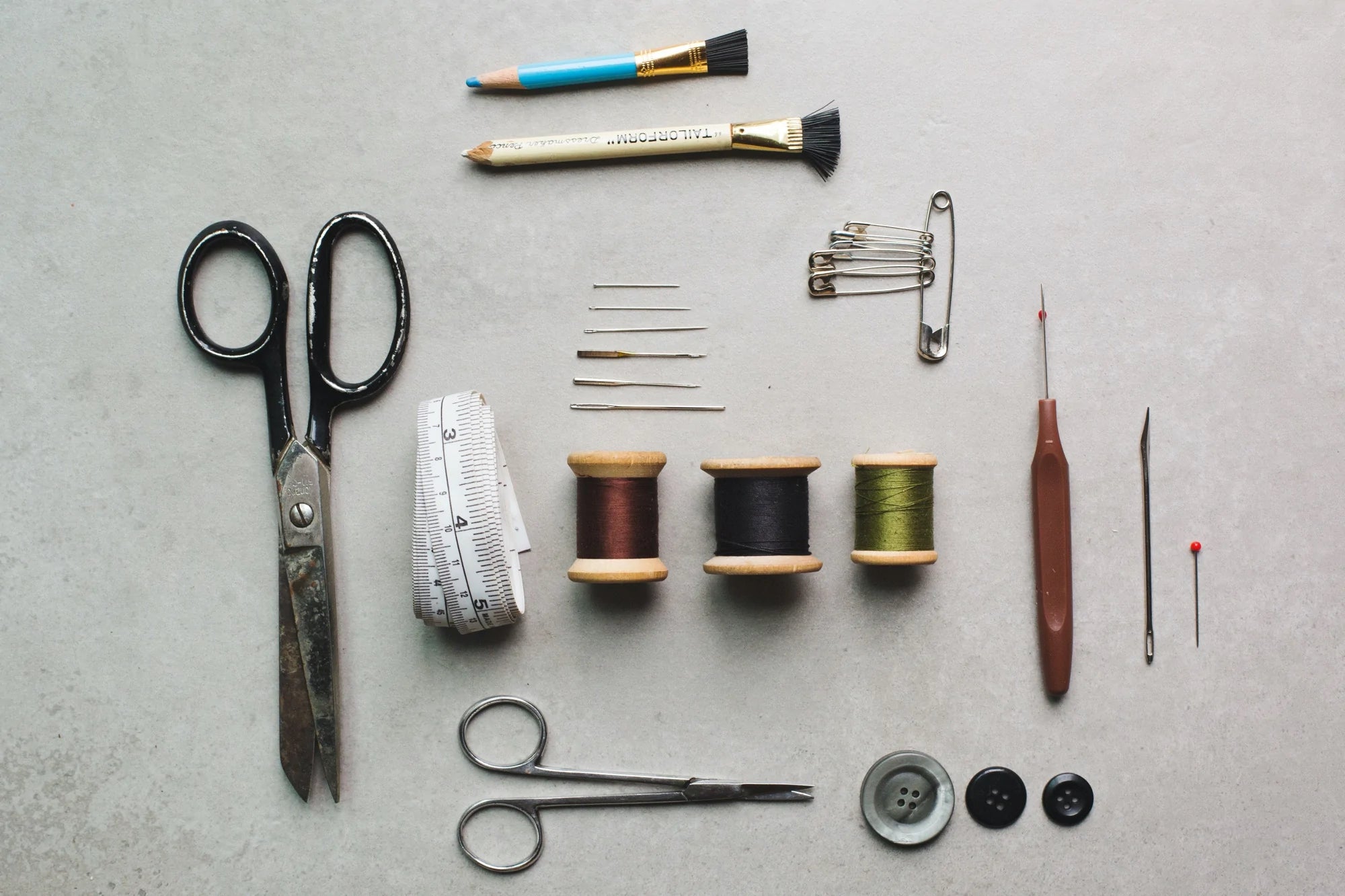 An array of sewing supplies arranged in a flatlay