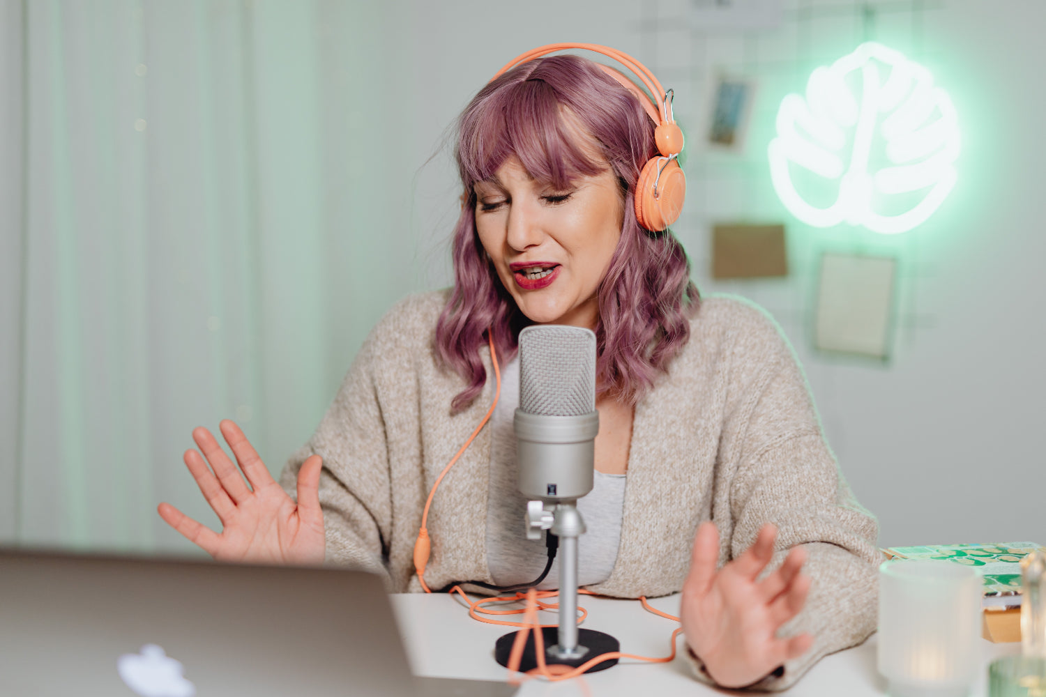 A woman speaks into a podcasting mic, showing one way to make money online