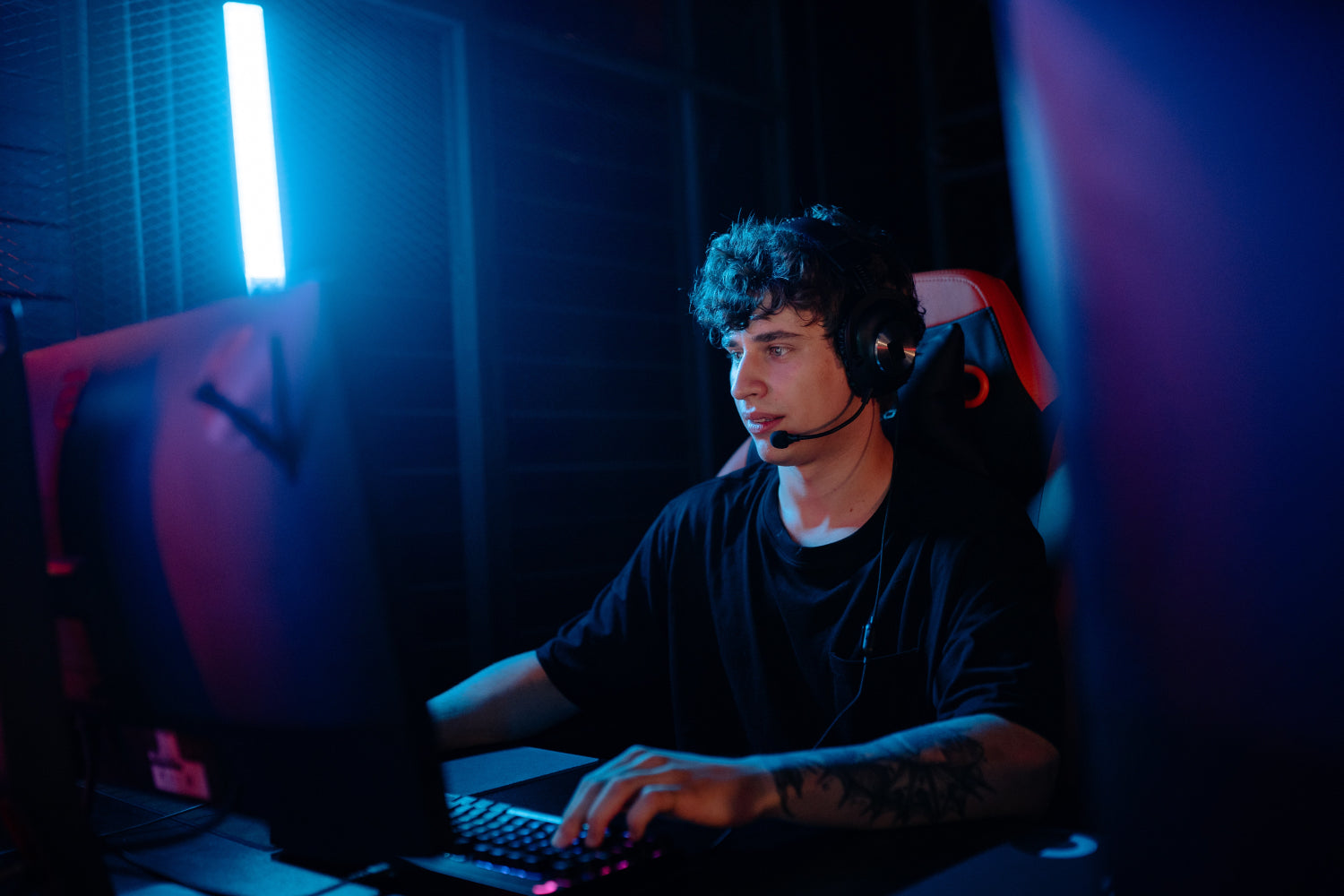 A young person makes money online wearing a headset and playing video games