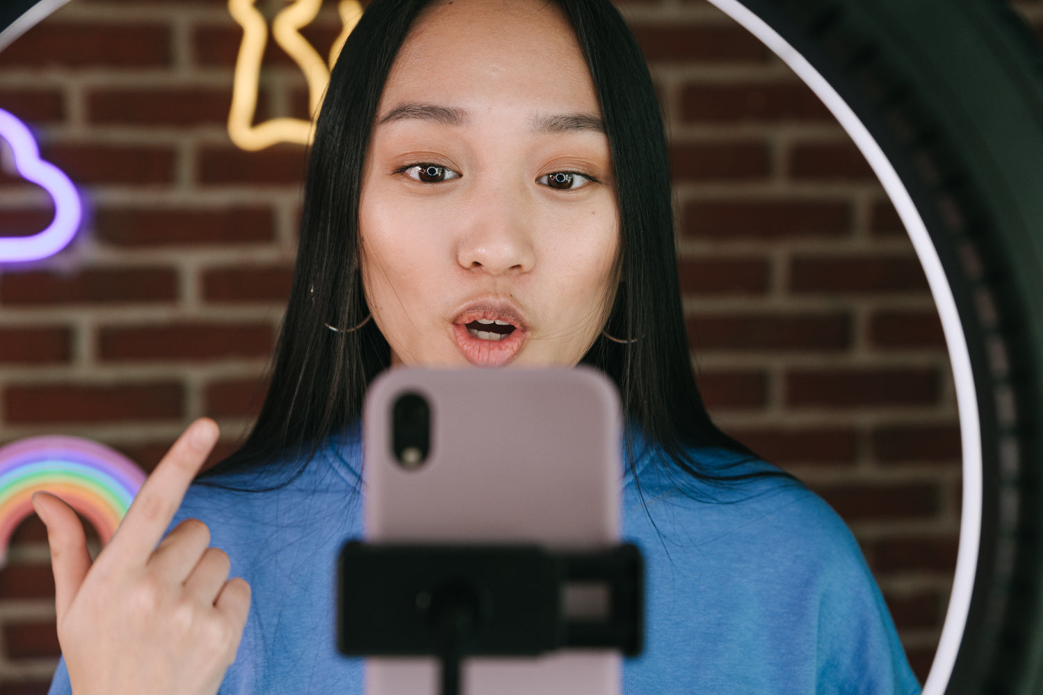 An influencer makes money online performing for a mobile phone camera