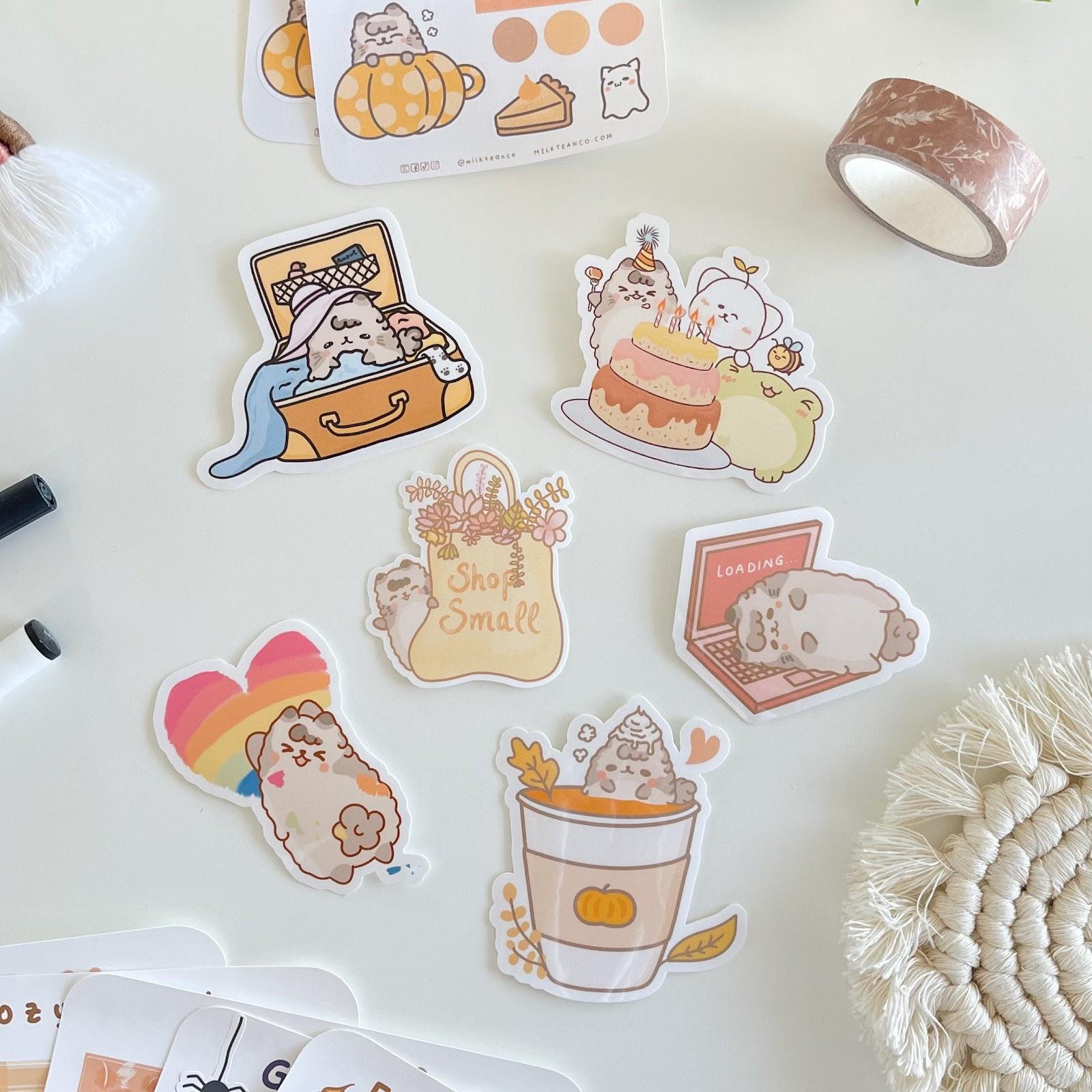 a selection of cute cartoon cat stickers including cats on laptops and in coffee cups.