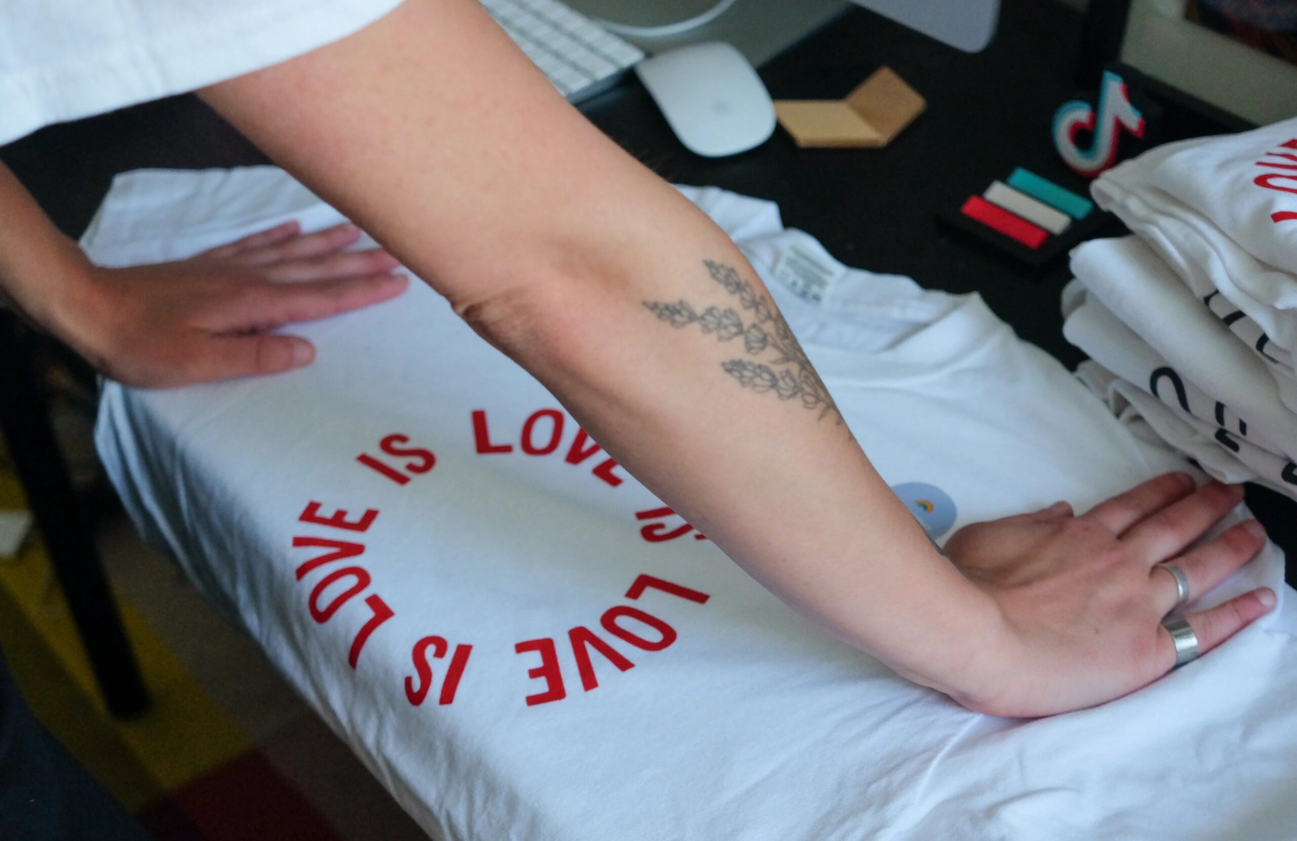 A person leans over a screenprinted tshirt