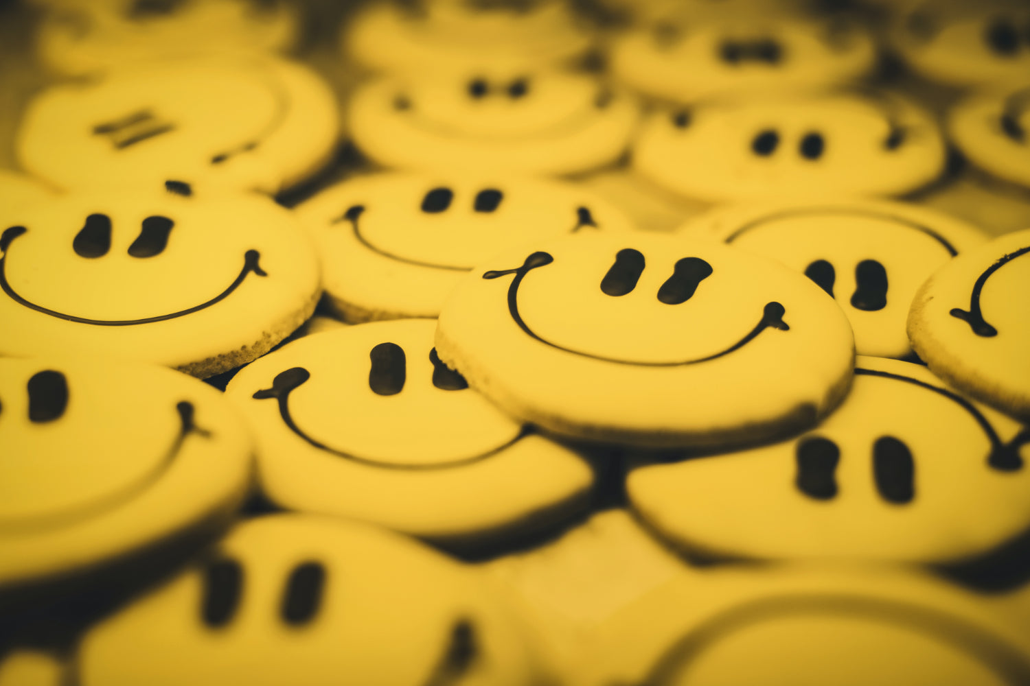 A stack of smiley face pinback buttons