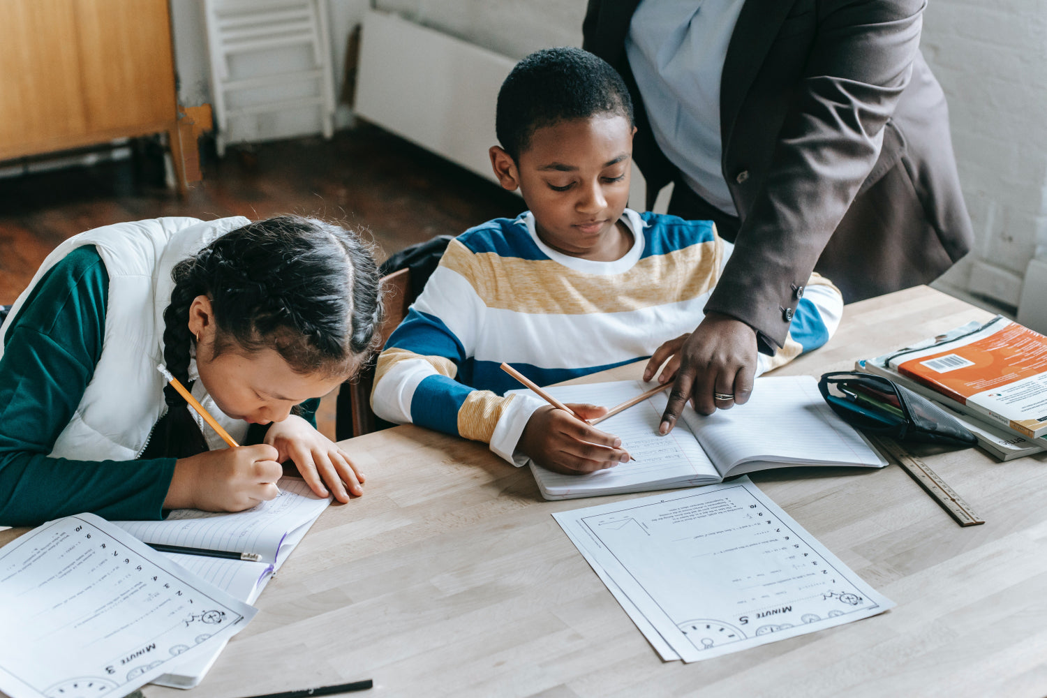 A tutor teaches two young children