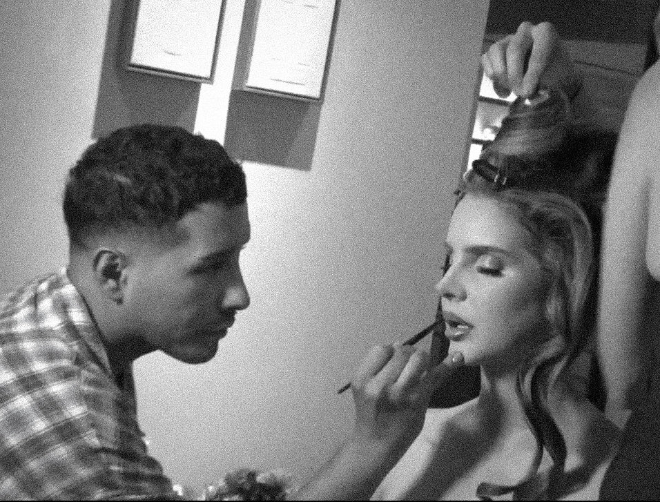 Etienne applies lip makeup on singer Lana Del Rey.