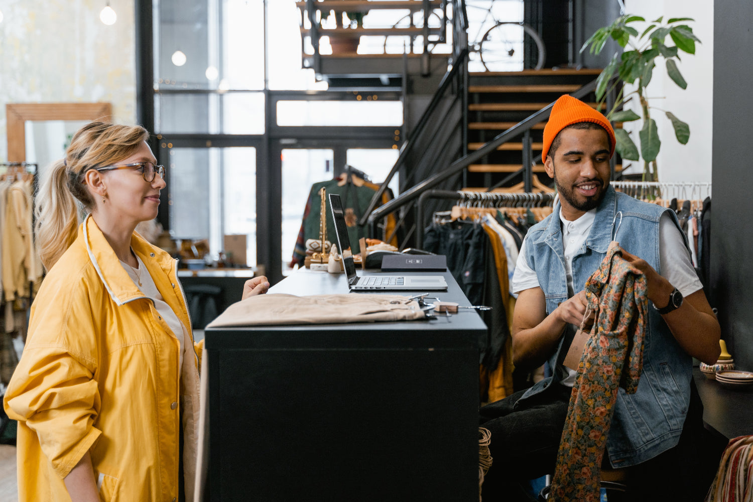 customer and shop owner engage at the register in a retail store: buy now pay later companies