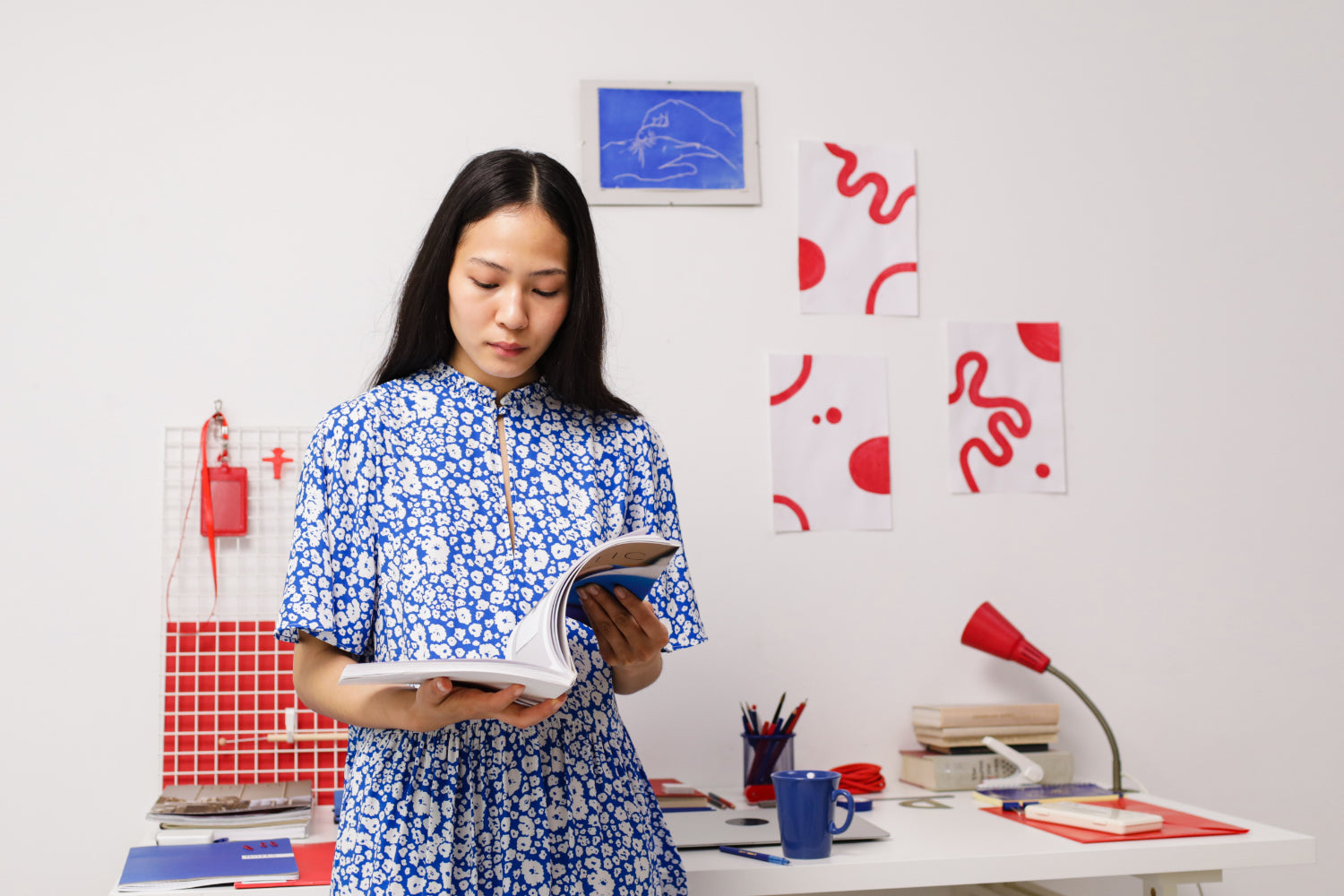 A woman reads a book in a studio office