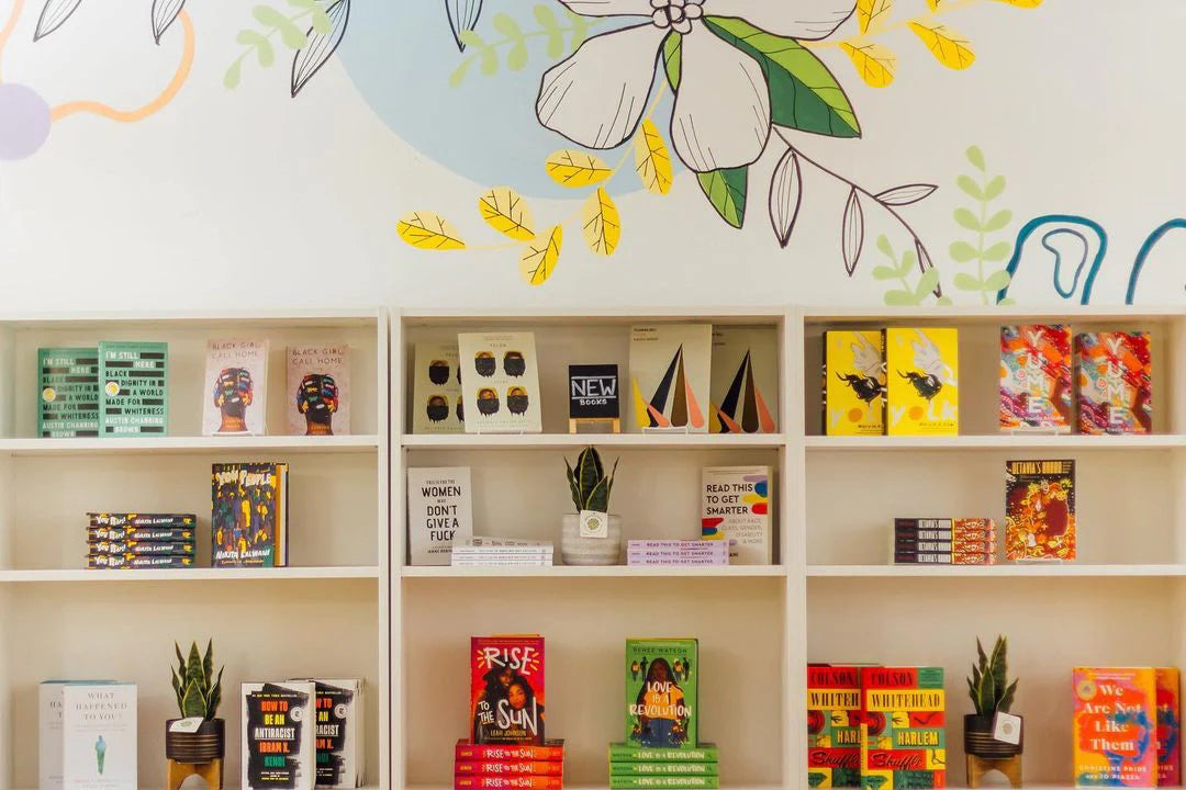 Bookstore interior with a floral wall mural and shelves of books