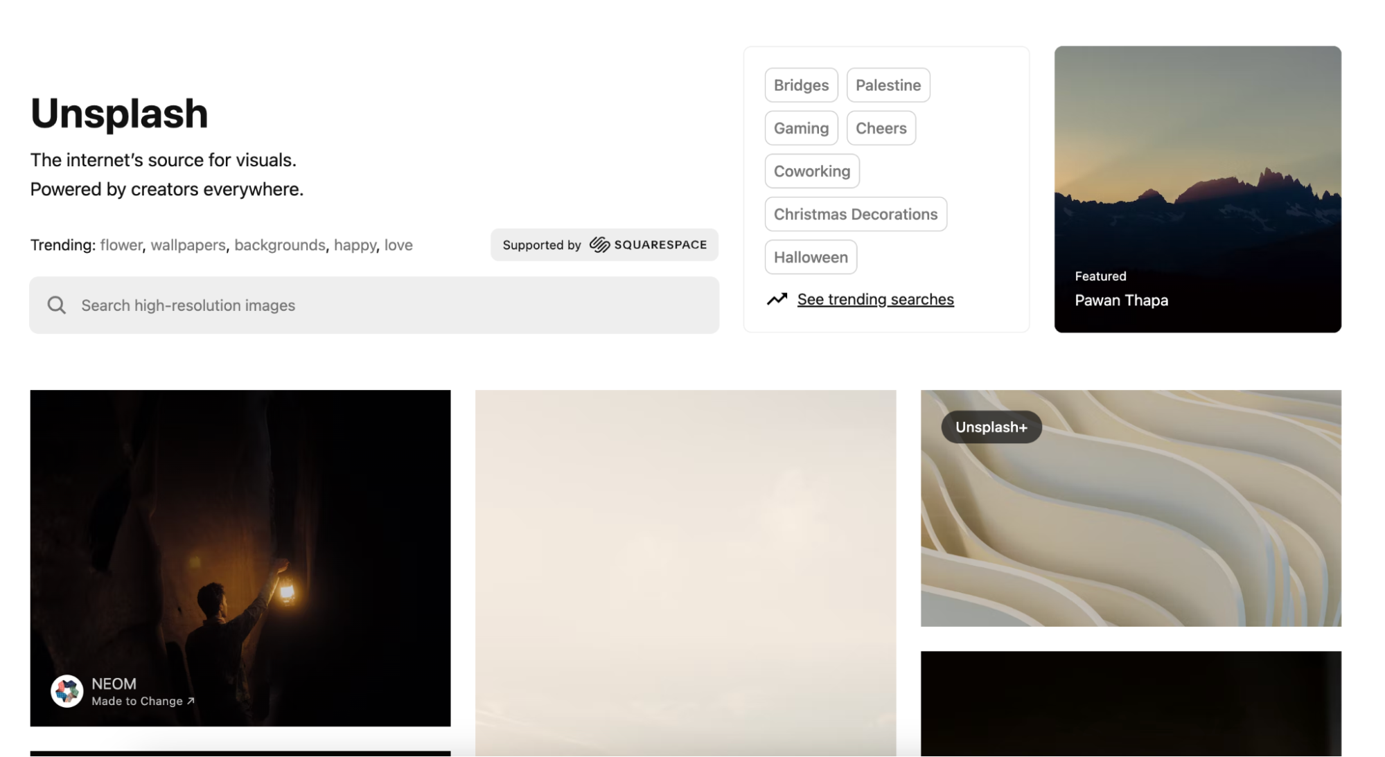 Unsplash homepage shows photo examples and search terms