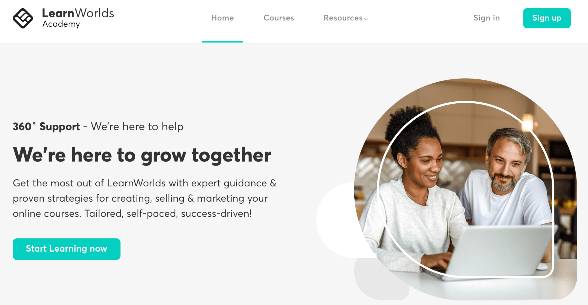 a screenshot of LearnWorlds Academy landing page showing a woman and a man working on laptop