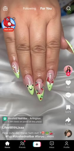 The first video on my “For You” page, showing a set of nails painted to resemble frogs.