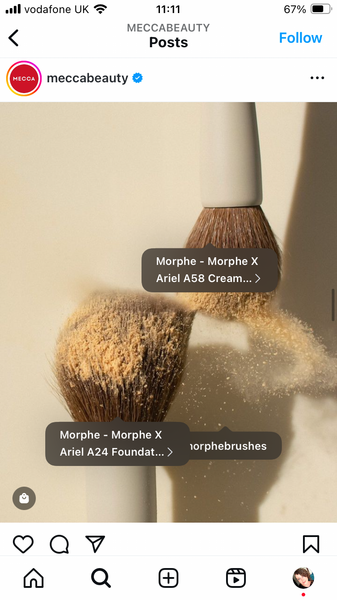 Shoppable post showing two makeup brushes and a plume of powder. Tags show what the products are.