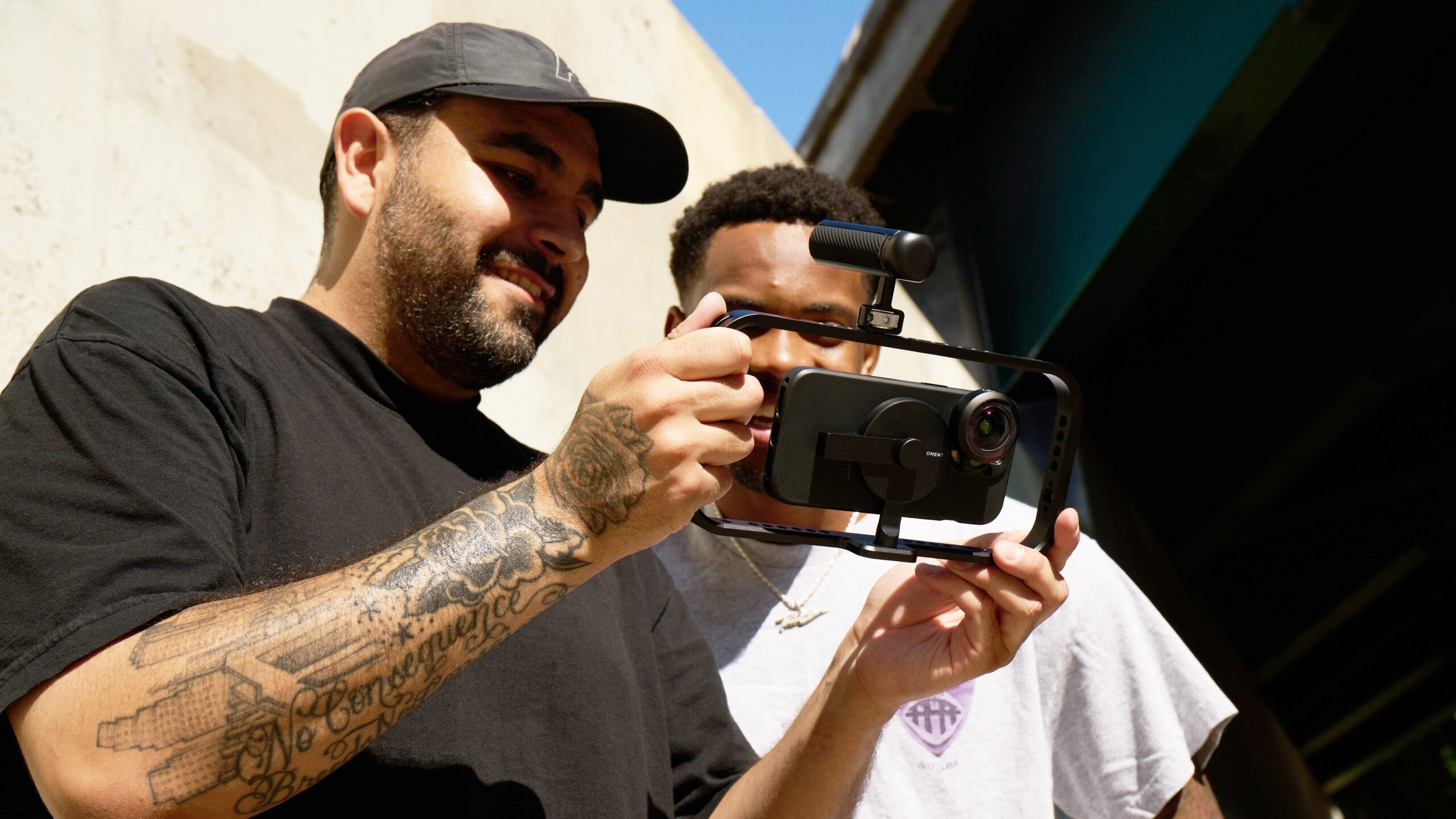 Two men looking a phone on a gimbal