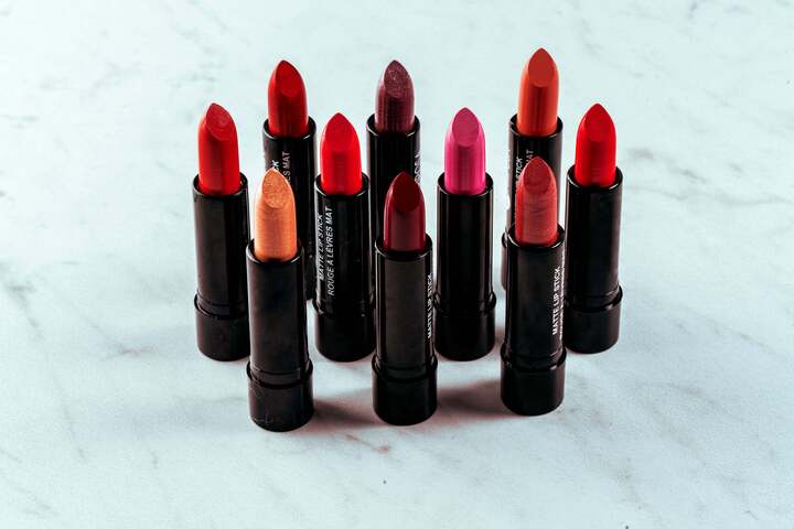 Ten sticks of lipstick standing upright to show off their true colors.