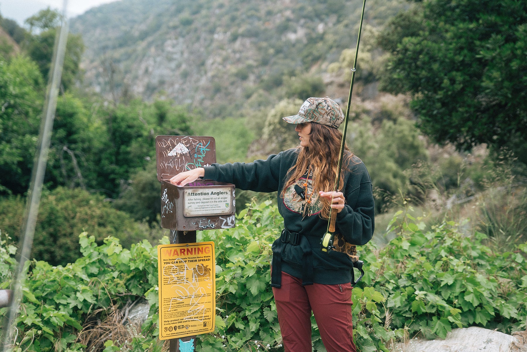 a woman in adjusting line on her fishing rod