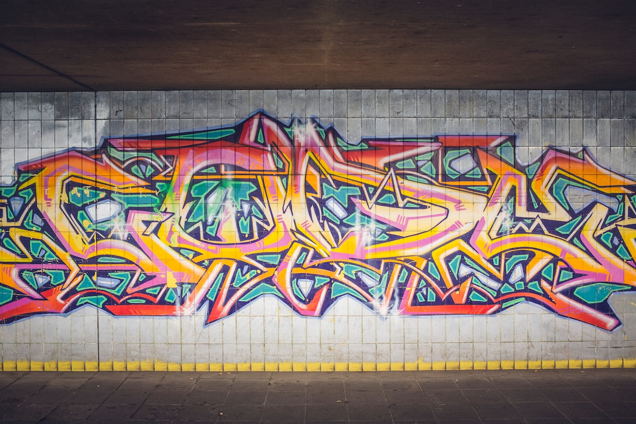 A word spray painted on a wall in wildstyle graffiti font.