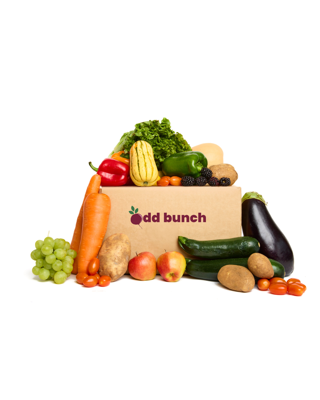 An Odd Bunch box with imperfect fruits and vegetables resting on top and around the box.