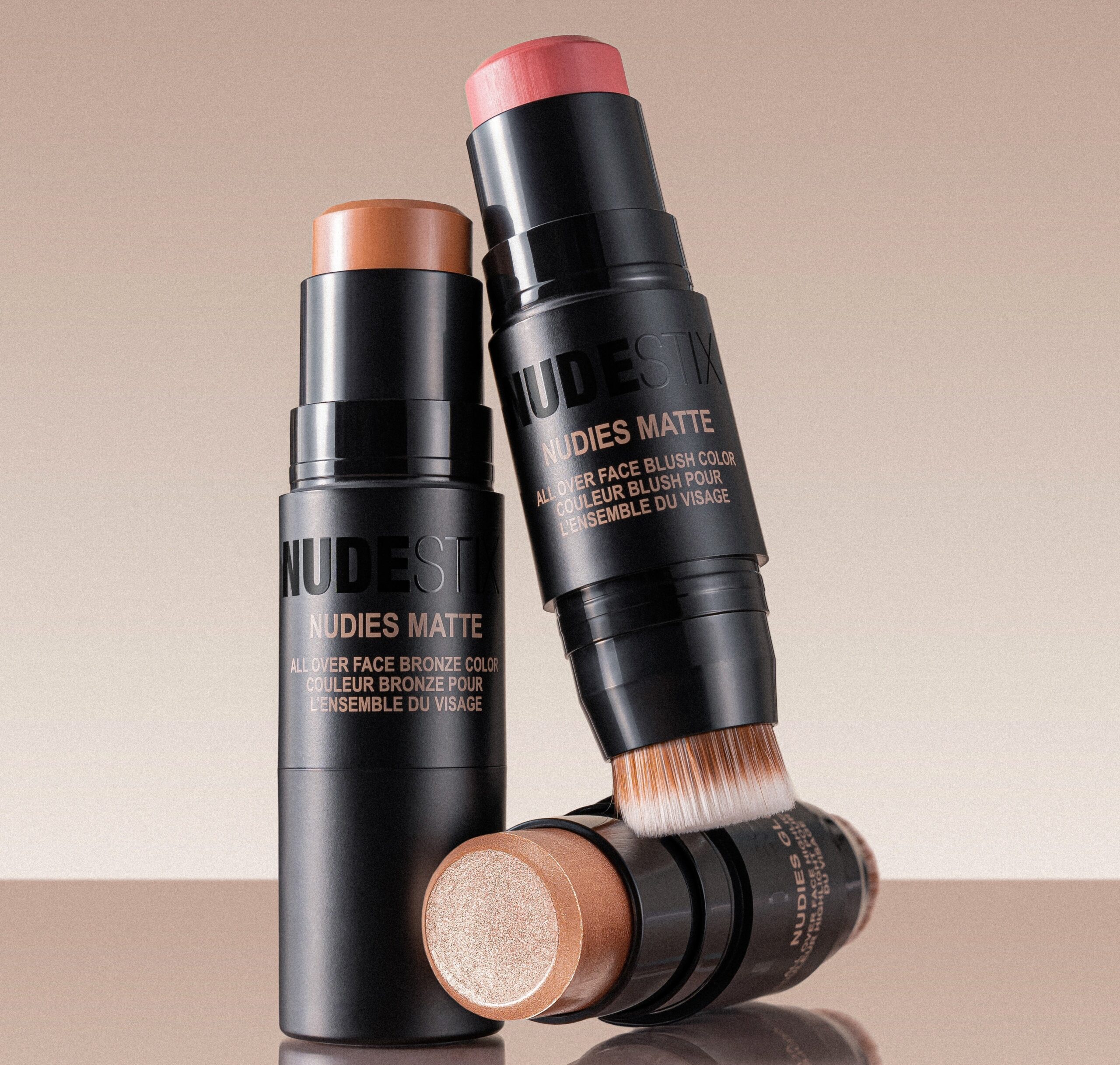 The NUDESTIX Nudies Matte All Over Face Bronze sticks resting on each other.