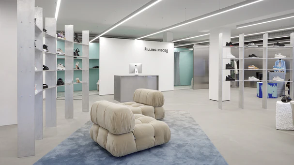 Shoe store with ceiling-mounted downlights.
