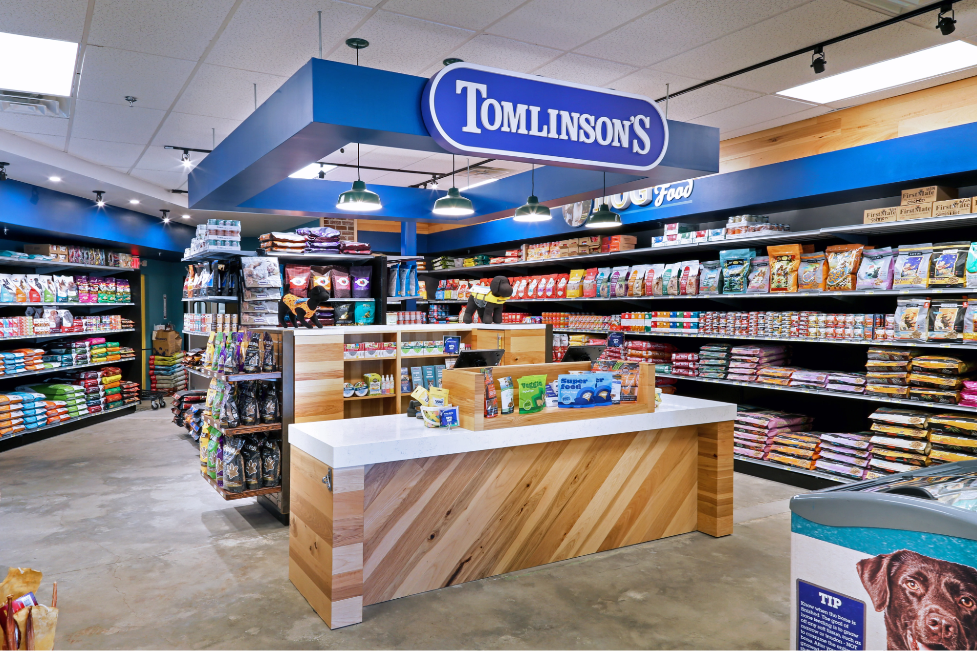 Wooden checkout desk in the center of a pet food store.
