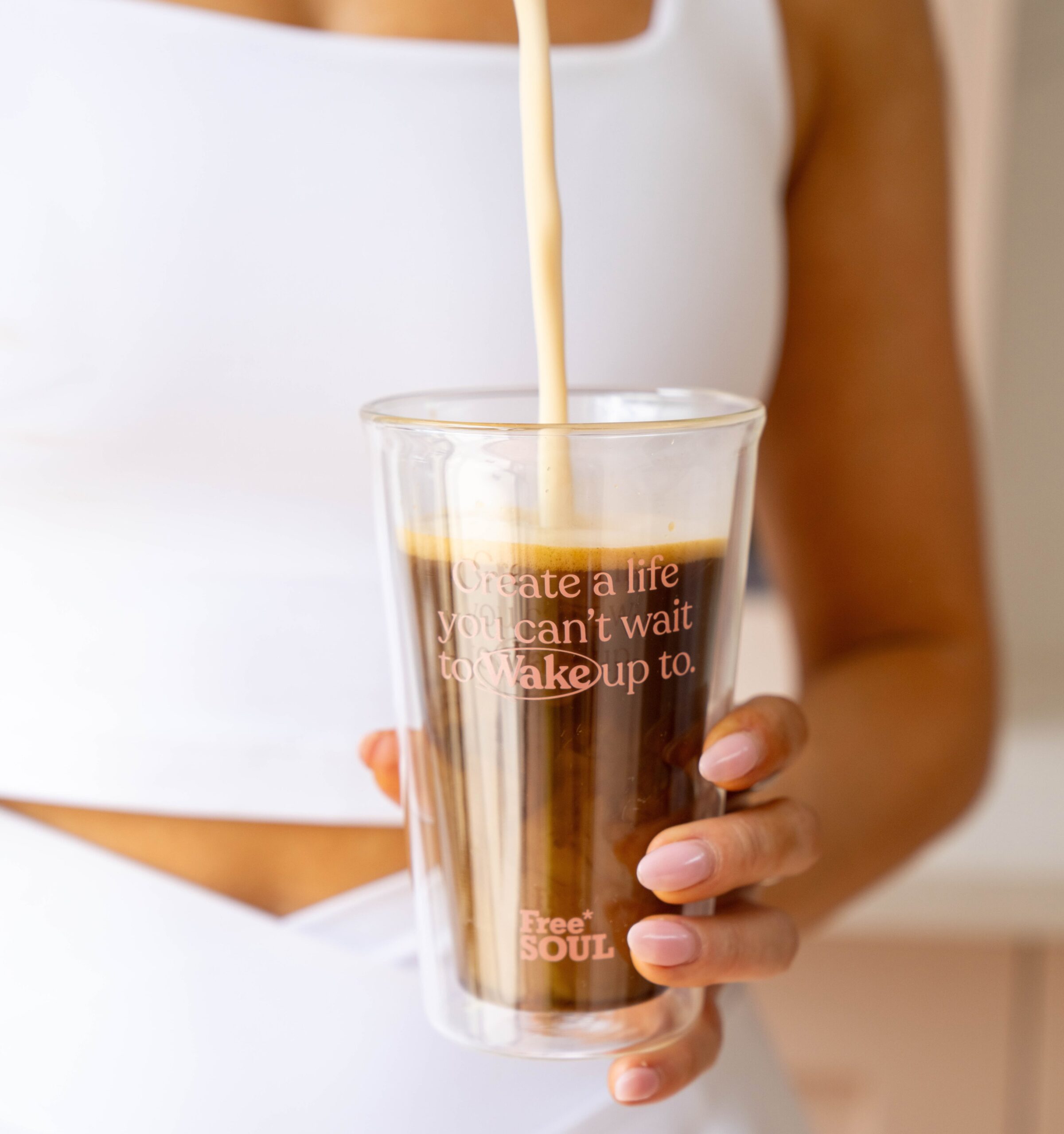 A model holds a Free Soul Wake Coffee Mug.
