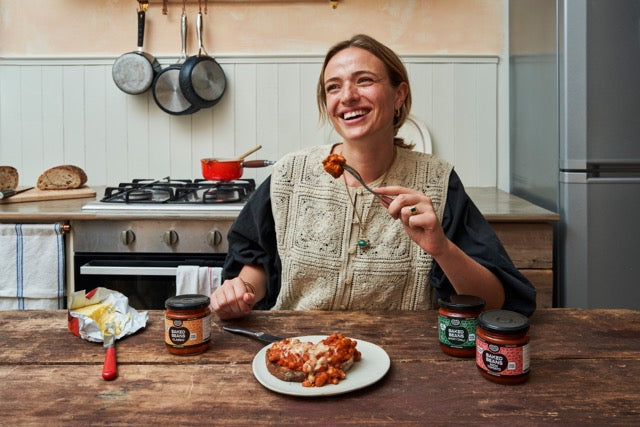 Woman eating beans at a table