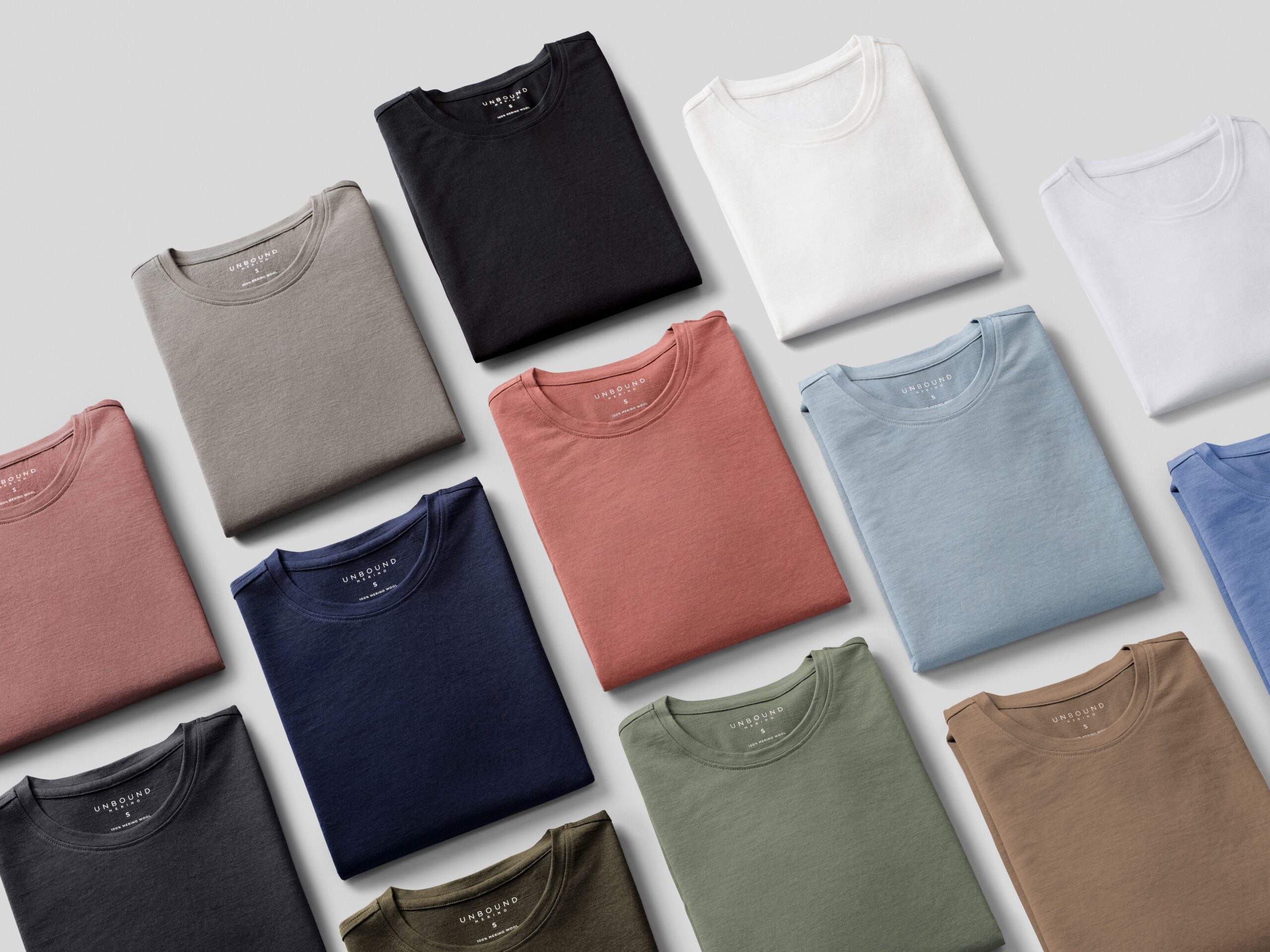 Unbound Merino’s women’s t-shirts folded on a white background, side-by-side.